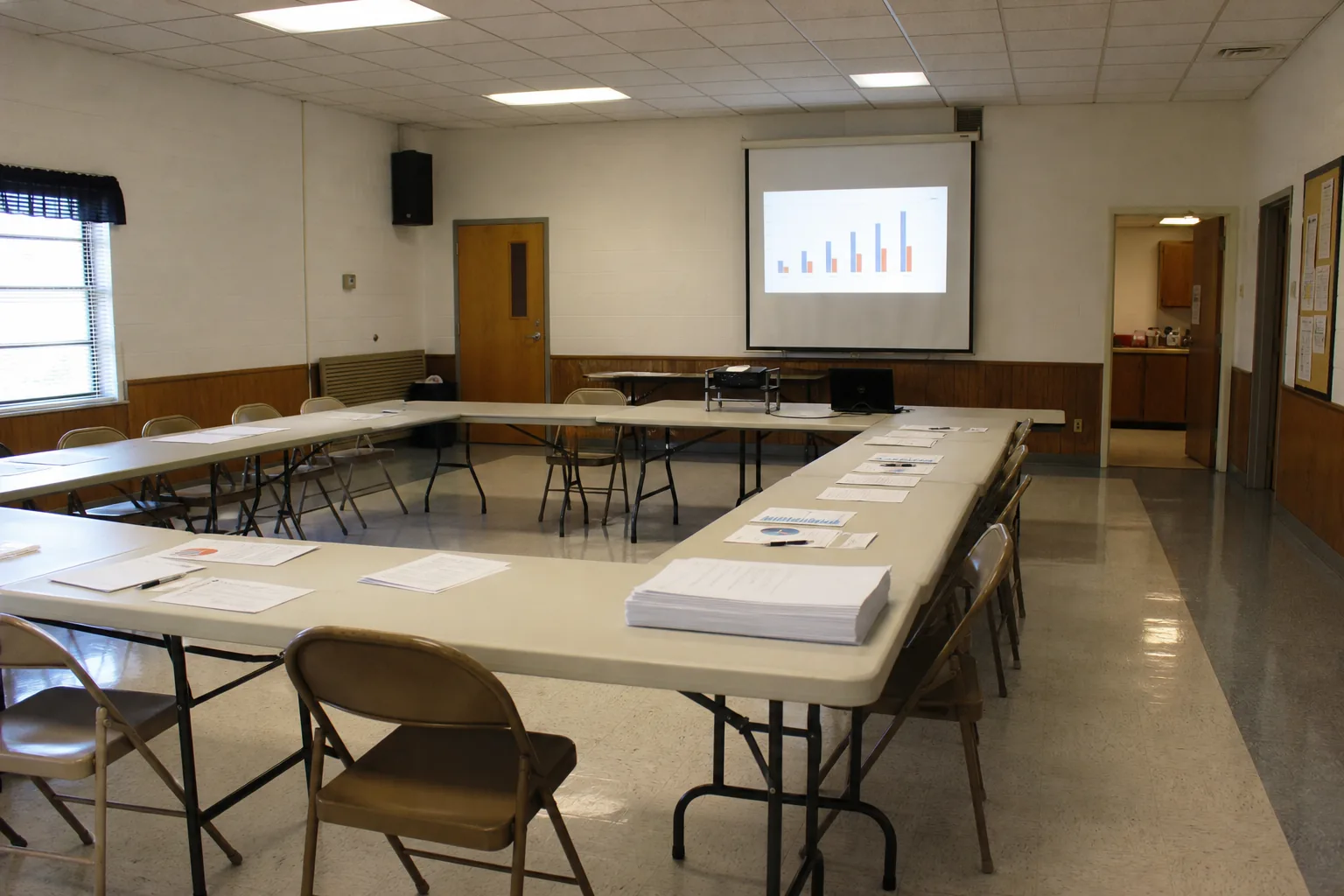 Community center meeting room with reports and charts for mission-driven AI planning