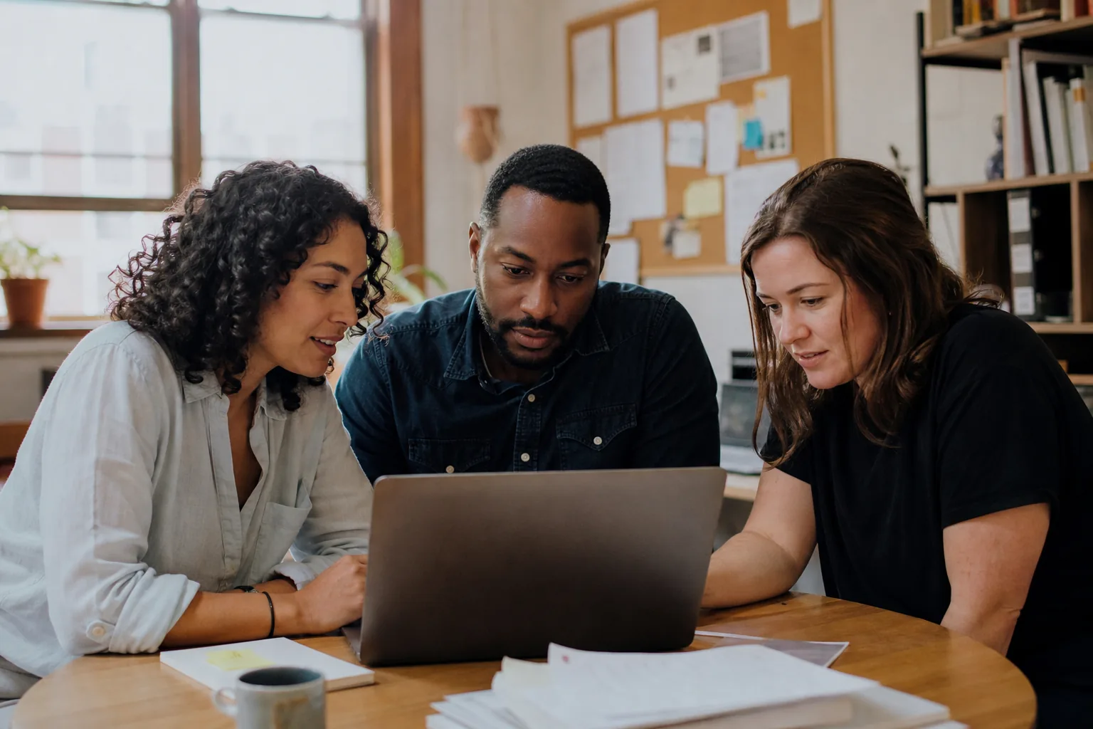 Nonprofit team reviewing program data together in a small mission-driven office